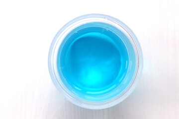 Washing gel in a measuring glass top view. Blue wash gel
