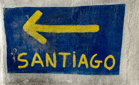 Arrow on a wall indicating to pilgrims the direction to walk in Saint Jacob way, Camino de Santiago