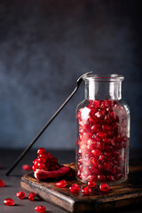 peeled ripe pomegranate seeds in a glass bottle