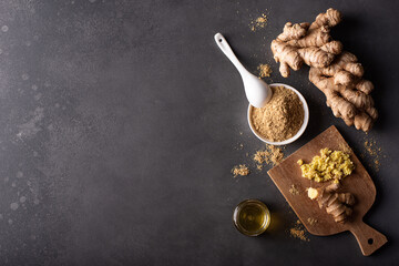 ginger root and ground dried ginger on a dark background