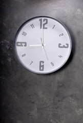 wall clock at concrete painted background