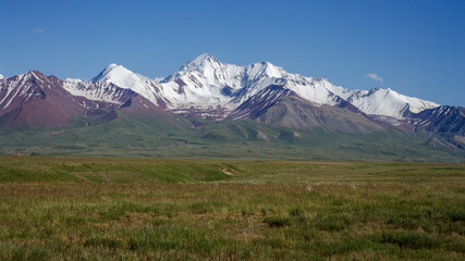 Fototapeta premium View of the snow-capped Trans-Alay mountain range from the road between Sary Tash and high altitude Kyzyl Art pass in southern Kyrgyzstan leading to the border with Tajikistan