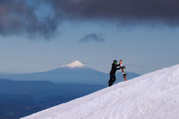View on Mount Taranaki from Turoa Skifield, snowboarder in background, winter season, New Zealand