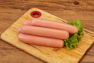 Tasty meat sausages over board