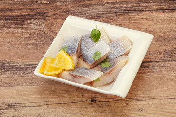 Herring fillet with sliced lemon