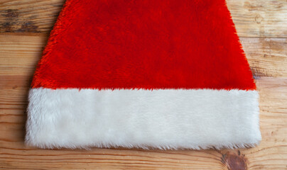 Obraz na płótnie Canvas Santa hat on a wooden background, Christmas banner