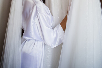 a bride in a peignoir with a wedding dress