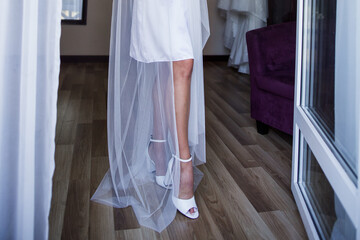 Fototapeta na wymiar bride in the morning in a negligee at the wedding