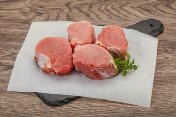 Raw pork medallion served rosemary