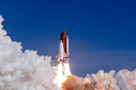 The launch of the space shuttle against the background of the sky and smoke. Elements of this image furnished by NASA