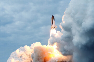 The launch of the space shuttle against the background of the sky and smoke. Elements of this image furnished by NASA
