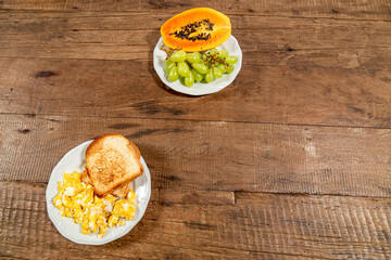 Rustic wooden table, top view and space for text. Plate of toast with eggs.