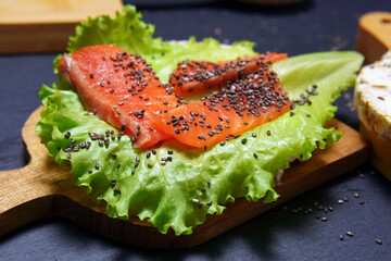 Sandwich with salmon fillet, with cream cheese lettuce and Chia seeds. close-up, selective focus