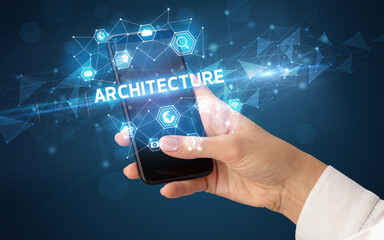 Female hand holding smartphone with ARCHITECTURE inscription, modern technology concept
