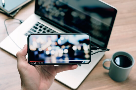 Closeup Image Of Man Hand Holding Smartphone And Watching Video In Horizontal View.