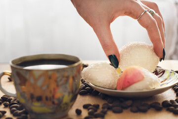gentle feminine hand, takes the air cookies with coffee