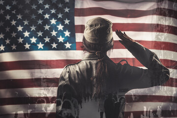 Celebration in the USA. A female soldier saluting, against the background of the American flag....