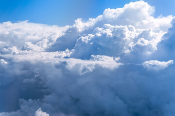 Fototapeta premium Aerial view flying above clouds in the atmosphere, depicts heaven. space for text
