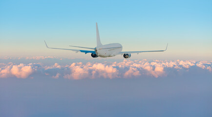 White passenger airplane over the clouds  - Travel by air transport