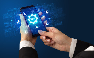 Female hand holding smartphone with VPN abbreviation, modern technology concept