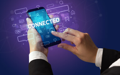 Female hand typing on smartphone with CONNECTED inscription, social media concept