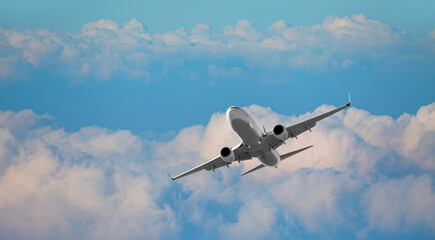 White passenger airplane over the clouds  - Travel by air transport