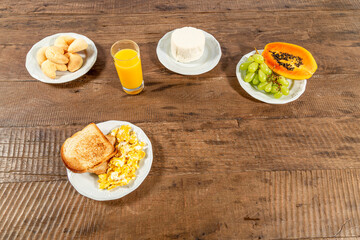 Breakfast table with papaya, grapes, toast and eggs. Space for text