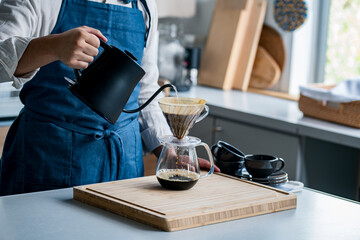 Fototapeta na wymiar Man making coffee in the kitchen. Delicious coffee image.