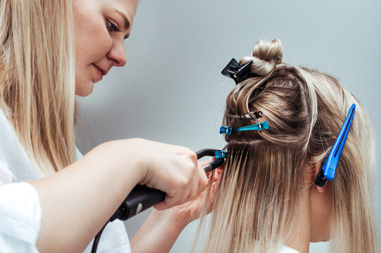 Hot hair extension process close up