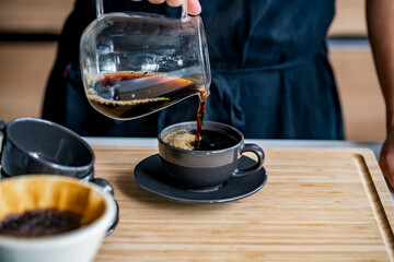 Man making coffee in the kitchen.
Delicious coffee image.