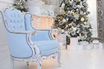 Celebratory New Year tree decorated with beautiful fur-tree toys and Christmas gifts in gift packages and celebratory boxes