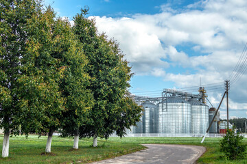 Grain-receiving enterprise - Construction of storage tanks cultivated agricultural crops processing plant. Industrial elevator dryers, building exterior. Agriculture crops storage concept
