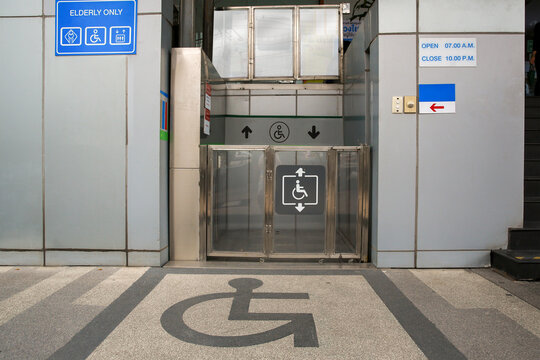 Elevator for people with disabilities. Disabled persons lift near modern apartment facility. The special elevator for the disabled at the entrance to the living house. Equipment with the wheelchair.