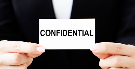 The businessman keeps a card with the text CONFIDENTIAL.