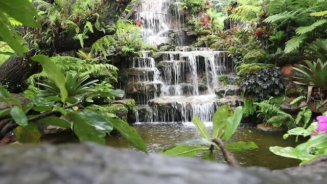 Natural waterfall in the forest is rich, beautiful and shady.