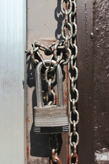 Lock with chain on a closed door. Closed on a chain with a lock a public place in the city centre.