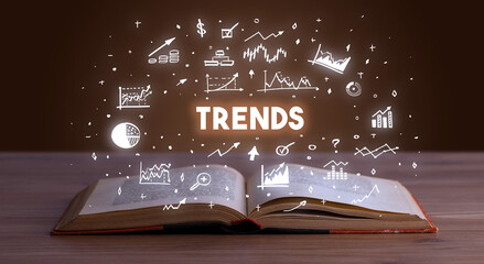TRENDS inscription coming out from an open book, business concept