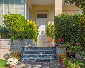 Fototapeta na wymiar cozy family house garden and front entrance door, Athens Greece