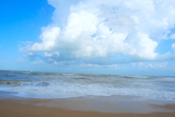 
view of the mediterranean sea in autumn. Seasonal storm. Blue sky, clouds and sand