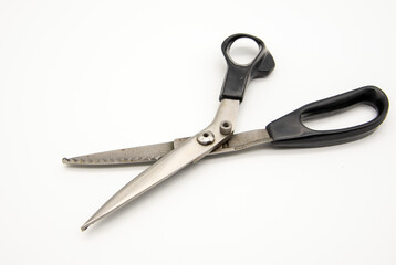 Old tailor scissors on a white background.