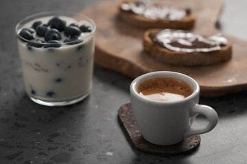 sweet breakfast with blueberry granola, ciabatta with chocolate spread and cup of espresso