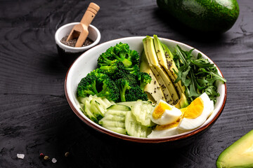 Detox spring salad with avocado, cucumber, broccoli and egg. Healthy organic vegan salat. Top view
