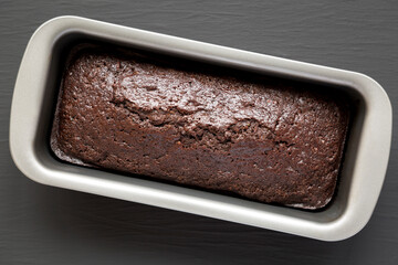 Homemade Chocolate Zucchini Bread on a black surface, top view. Flat lay, overhead, from above.