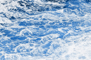 Ocean wave background. Bubble water backdrop. Turbulent sea texture. Messy water flow. Depth of the sea. Water foam surface backdrop.