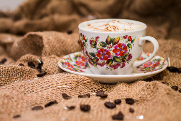 coffee with milk froth and coffee beans.