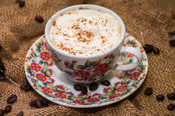 coffee with milk froth and coffee beans.