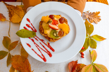 Autumn leaves thanksgiving fruit female hands hold cake plate white red yellow