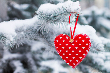 red heart on a tree in the snow