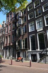Fototapeta na wymiar An empty street in Amsterdam, The Netherlands. Traditional dutch architecture. Vertical view