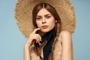 Romantic girl in a straw hat on a gray background and a beige sundress black ribbon emotions model